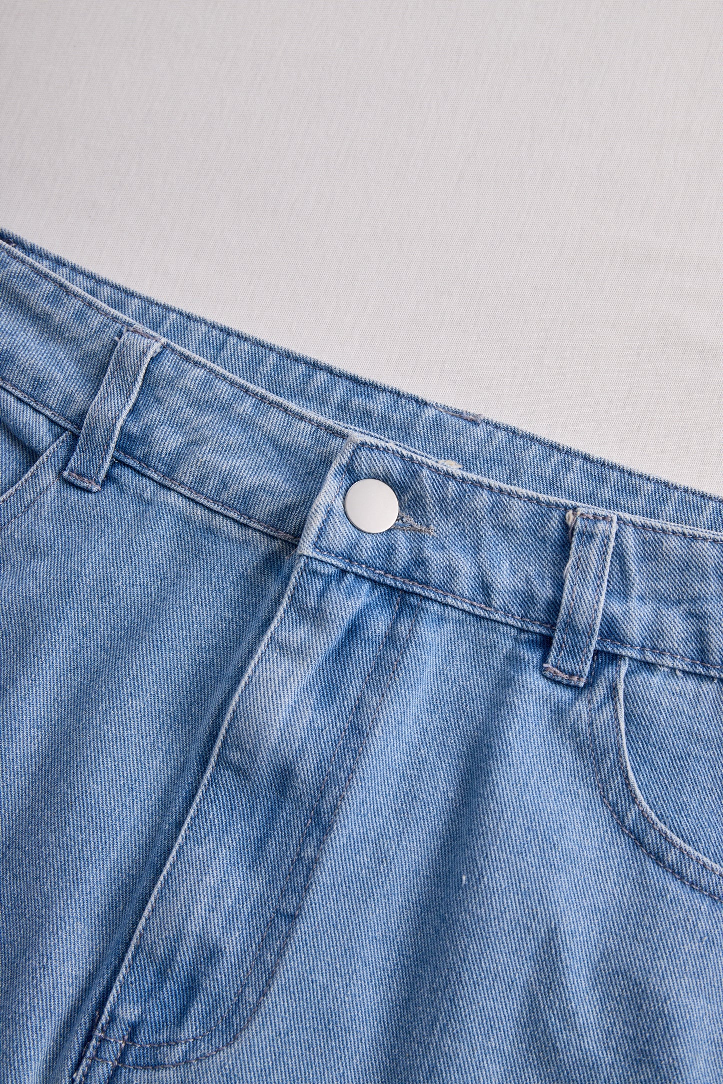 Stylish Denim Two-Piece Set With Asymmetrical Top And Fringed Skirt